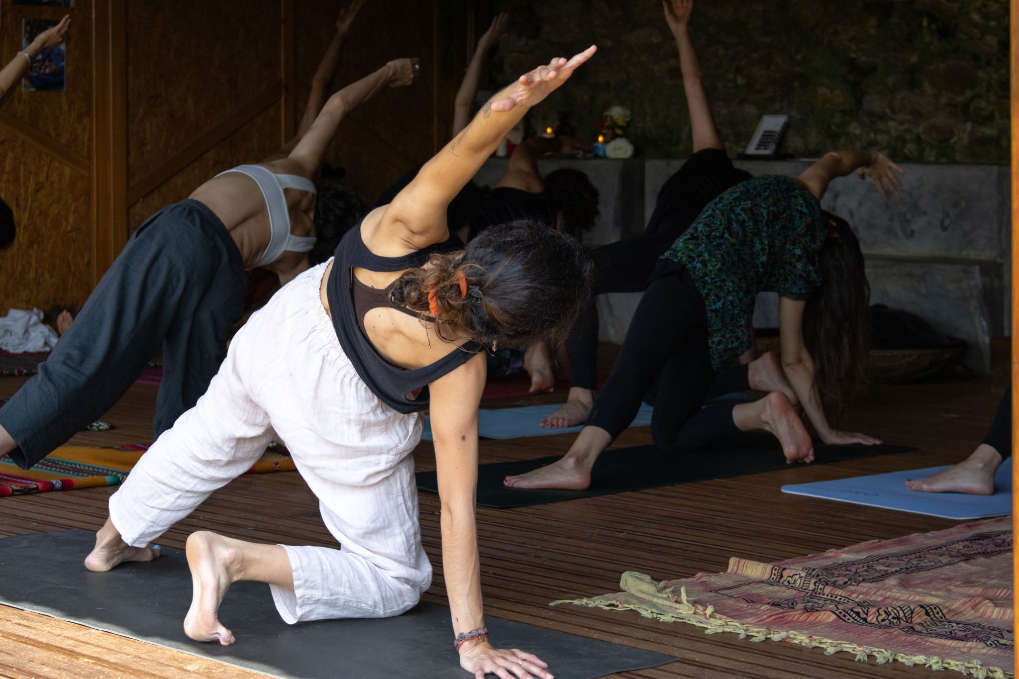 Group yoga class in a wooden studio