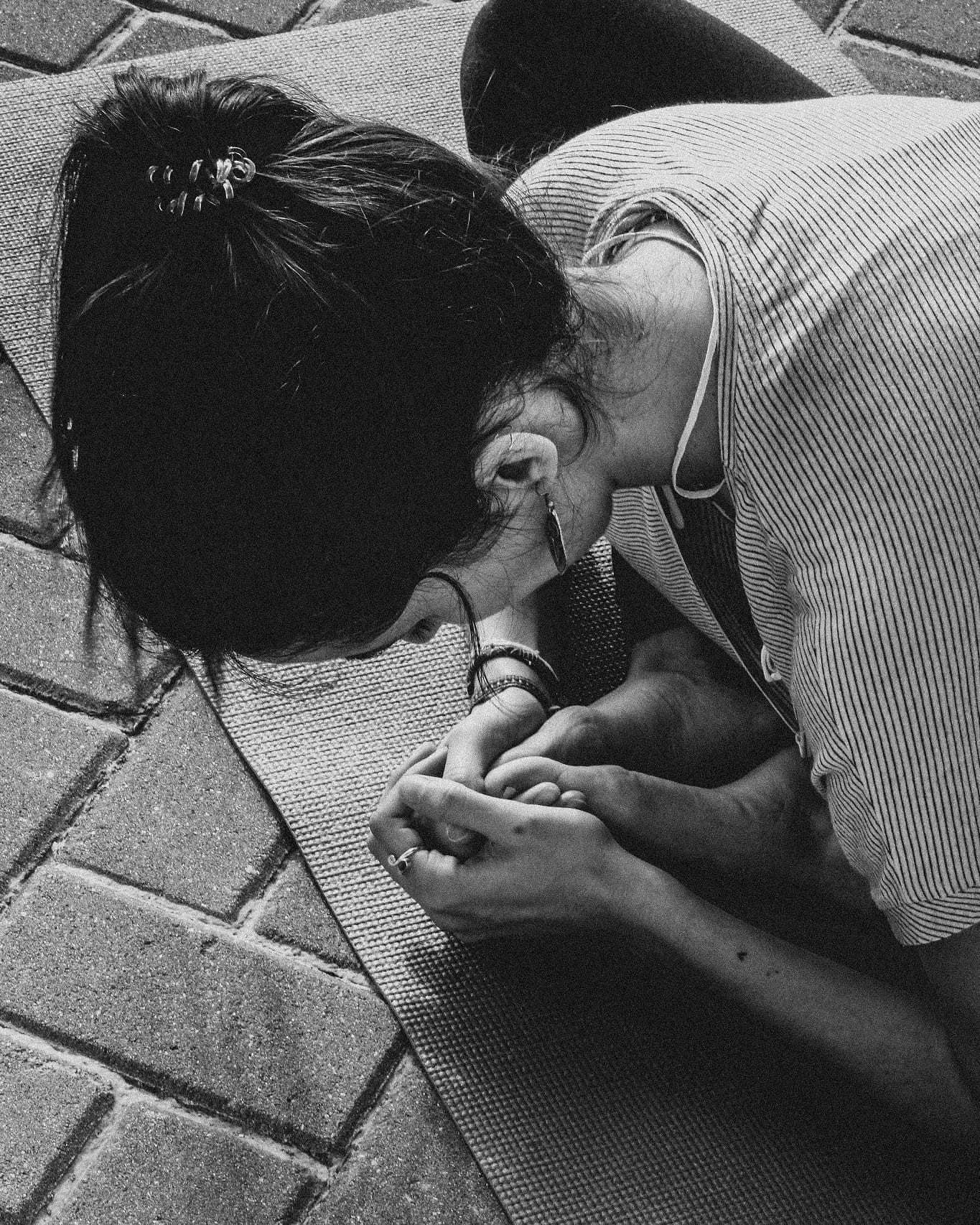 Black and white overhead view of a yoga forward fold